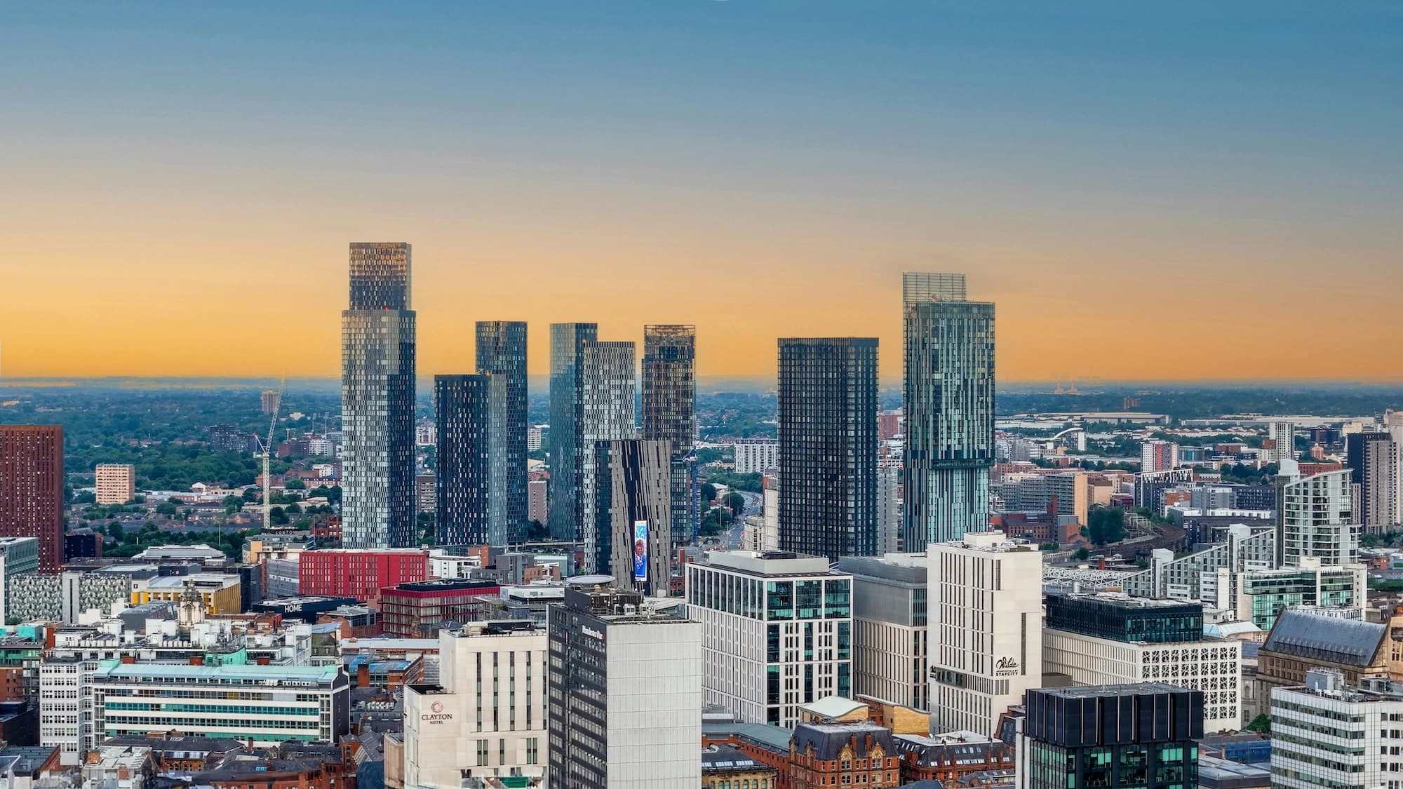 A skyline panaromic photo of Manchester, UK at sunset